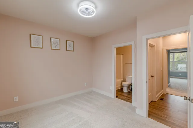 an empty room with closet and a bathroom