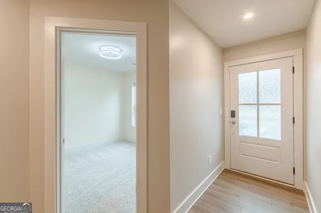 an empty room with windows and closet