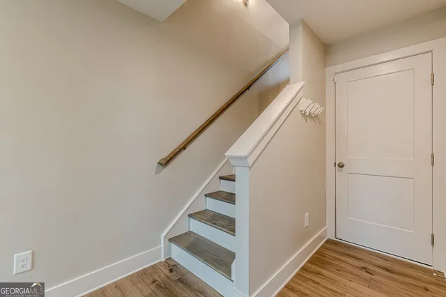 a view of entryway with stairs and wooden floor