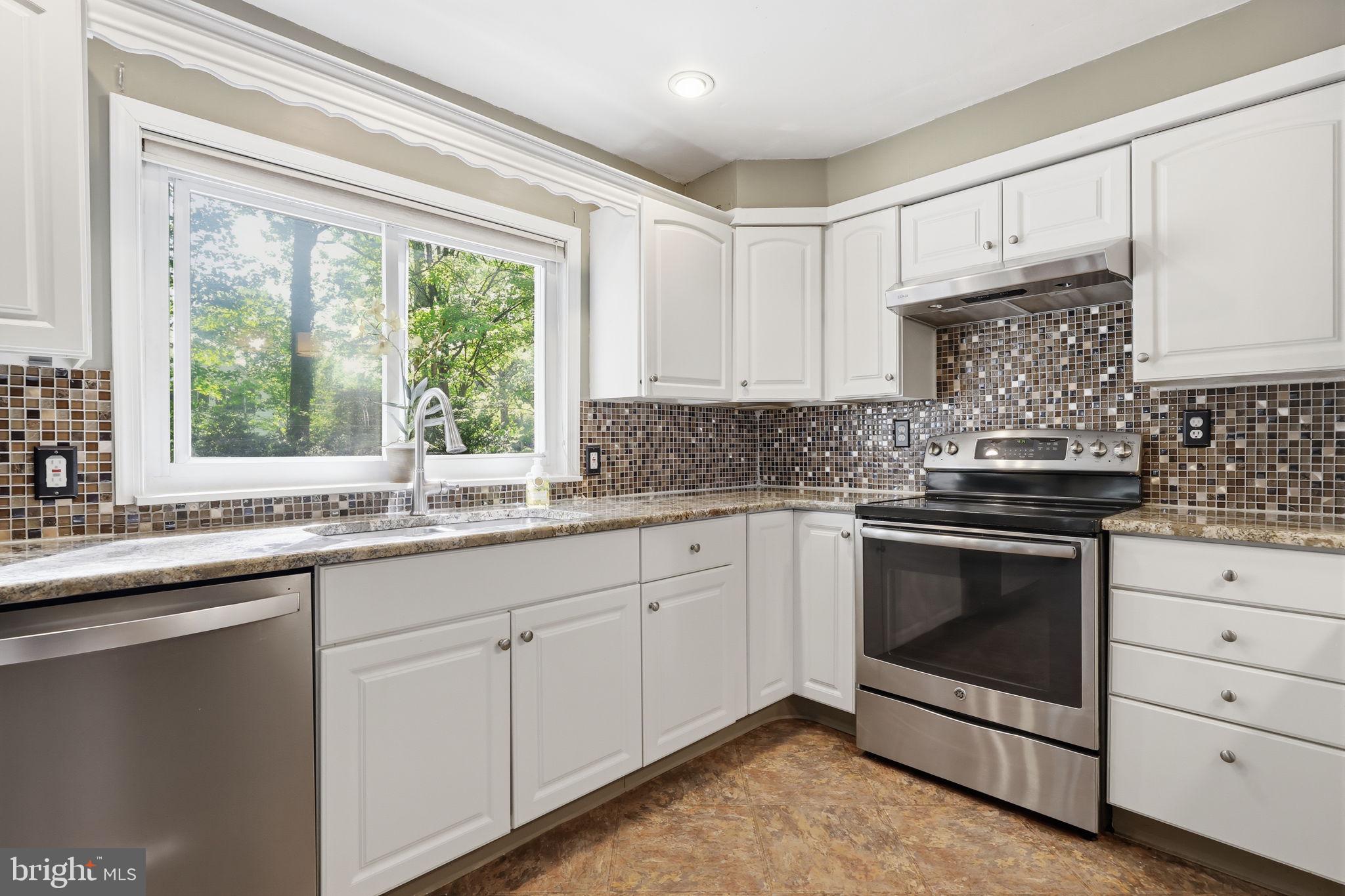 207 West Ferry Road Yardley, PA 19067 - Photo 17 of 50 a kitchen with granite countertop white cabinets white stainless steel appliances and a sink