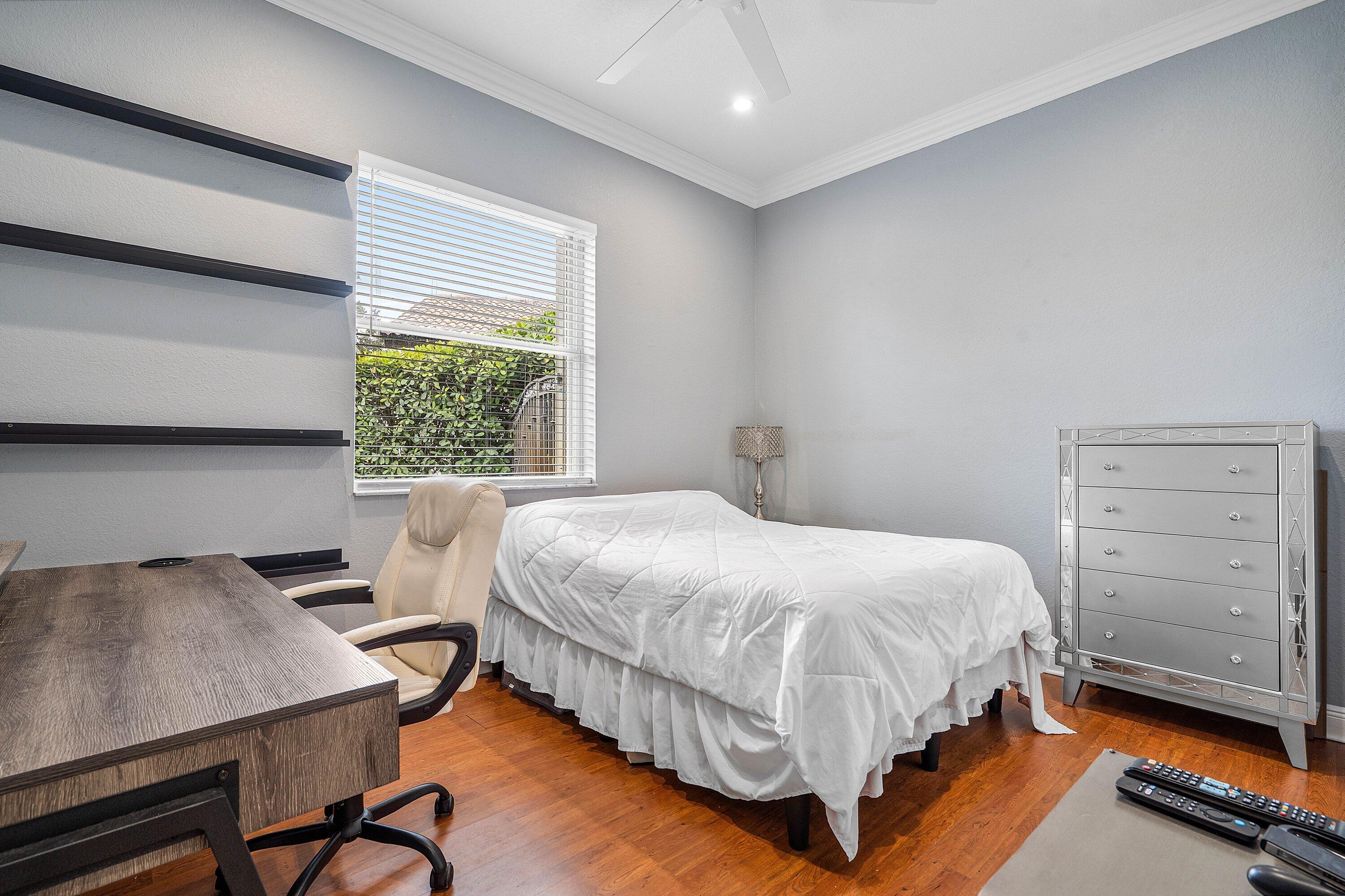 16852 Northwest 88th Path Miami Lakes, FL 33018 - Photo 18 of 34 a bed sitting in a bedroom next to a window