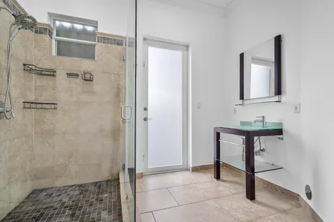 a bathroom with a shower and a sink