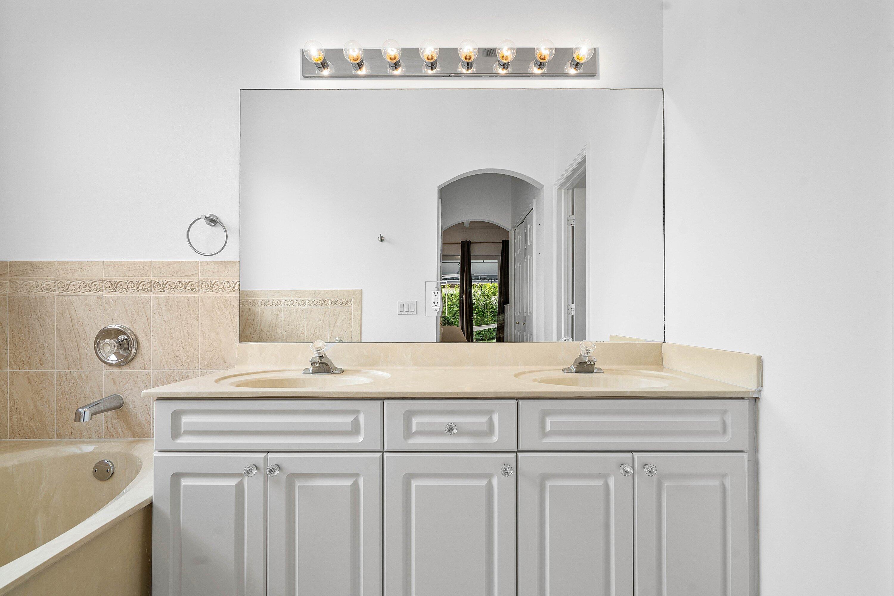 16852 Northwest 88th Path Miami Lakes, FL 33018 - Photo 25 of 34 a bathroom with a sink and a mirror
