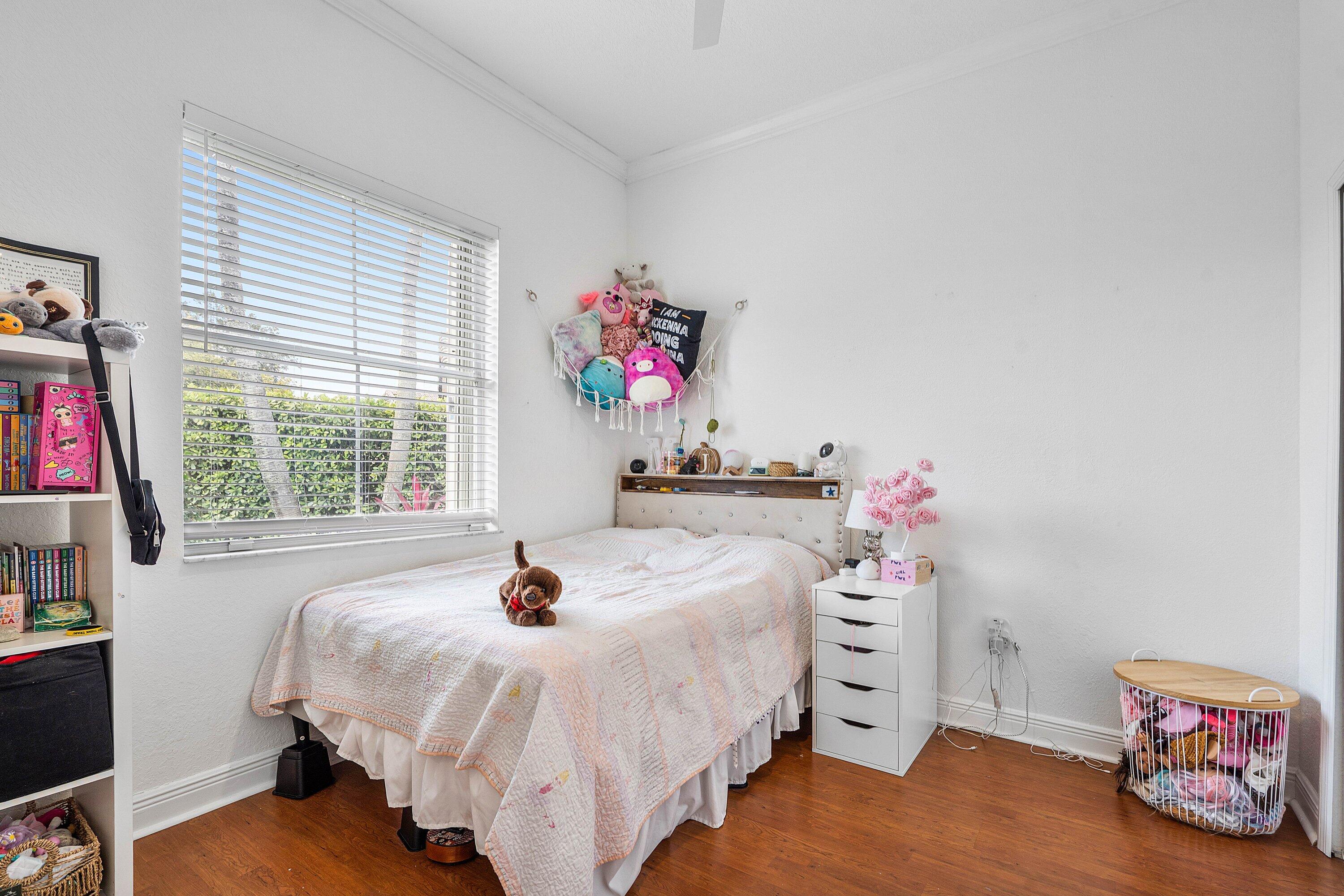 16852 Northwest 88th Path Miami Lakes, FL 33018 - Photo 26 of 34 a bed room with a bed and a window