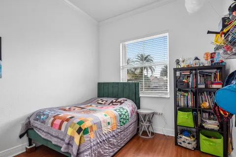 a bed sitting in a bedroom next to a book shelf