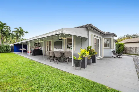 a front view of a house with patio and garden
