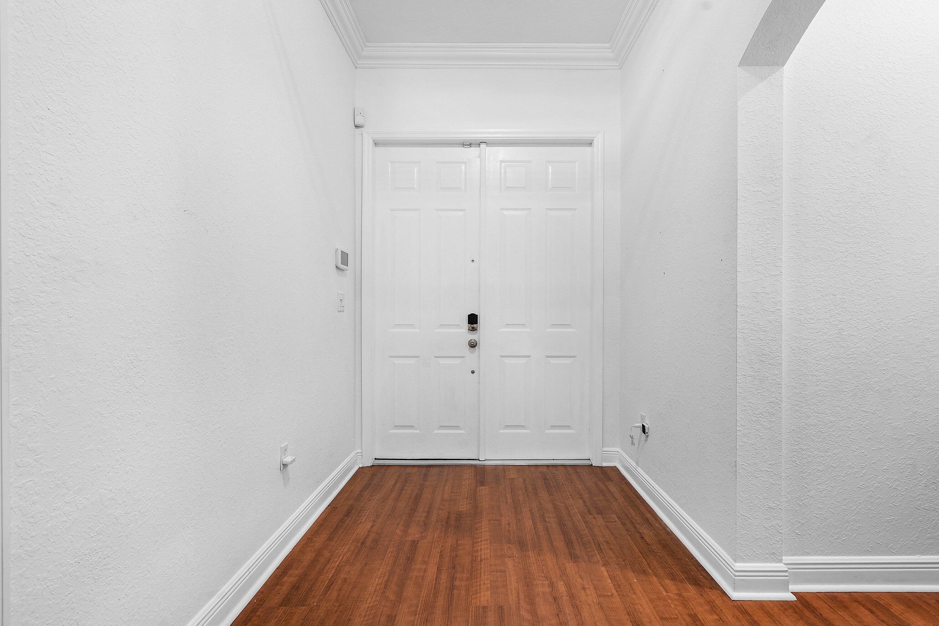 16852 Northwest 88th Path Miami Lakes, FL 33018 - Photo 4 of 34 a view of a room with wooden floor and white walls