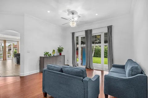 a living room with furniture and a chandelier