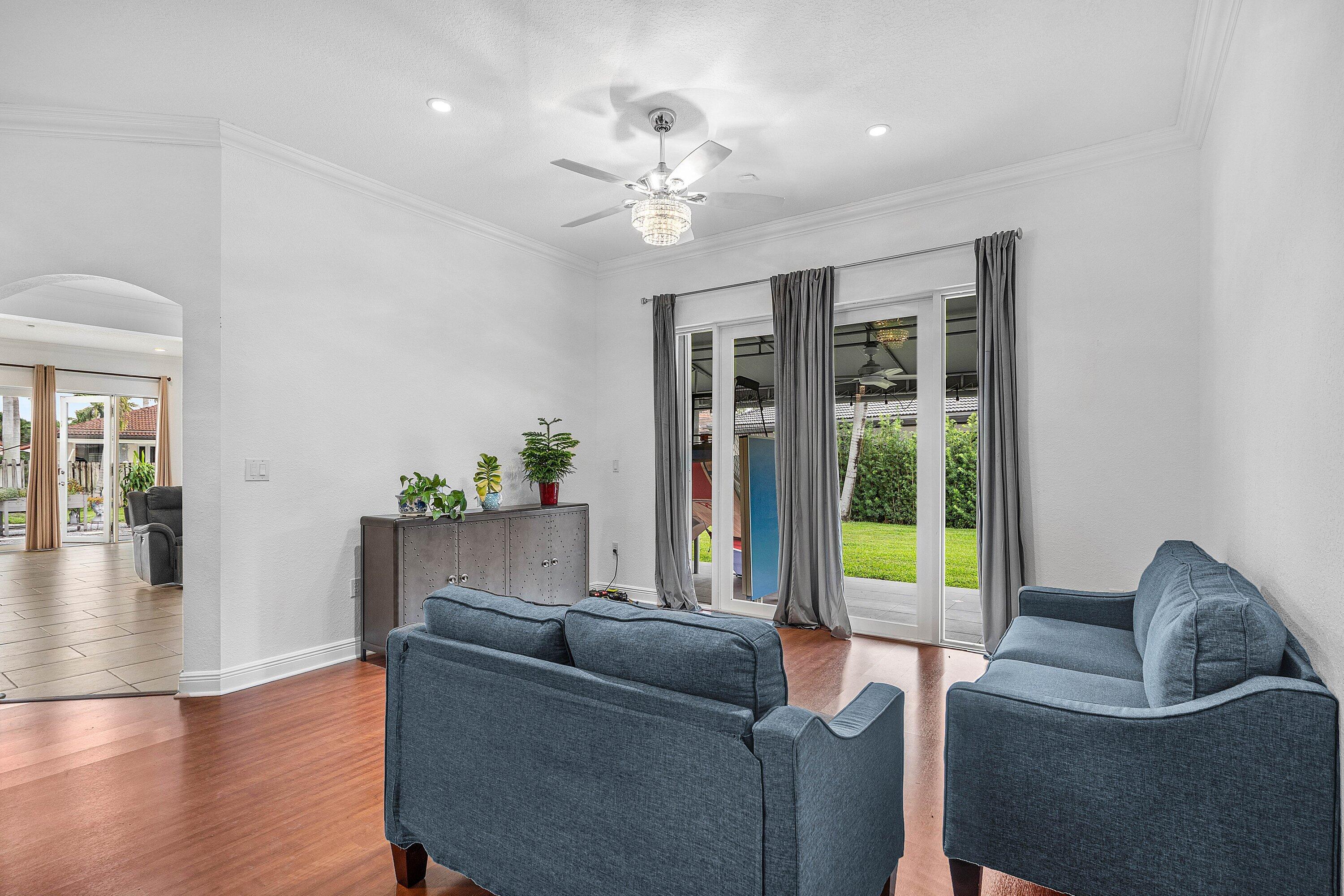 16852 Northwest 88th Path Miami Lakes, FL 33018 - Photo 6 of 34 a living room with furniture and a chandelier