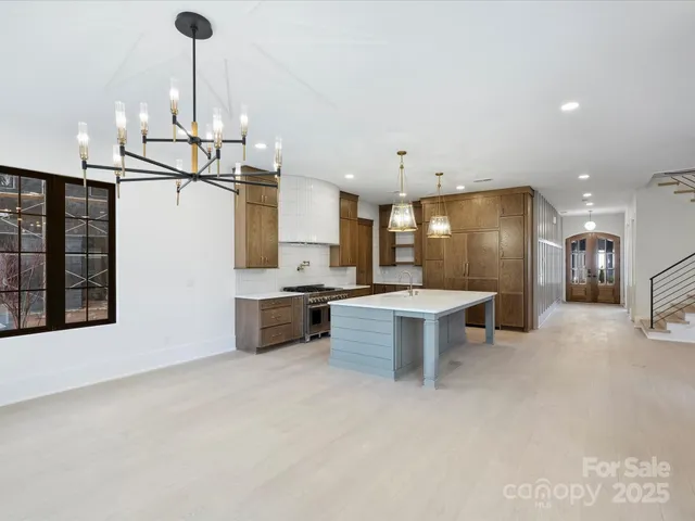 a large kitchen with a large counter top appliances and cabinets