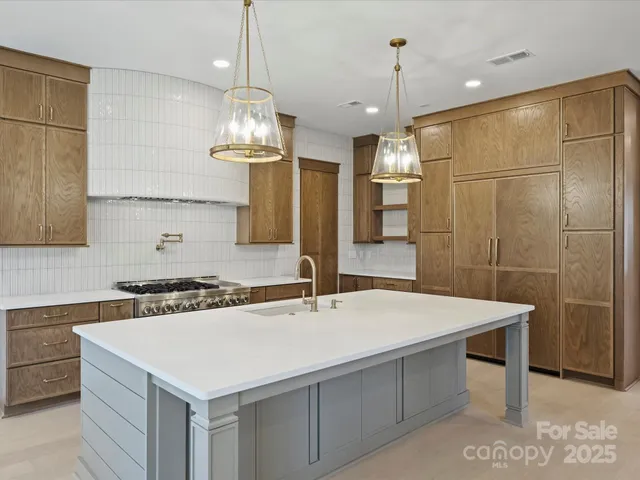 a kitchen with a sink a counter space and stainless steel appliances