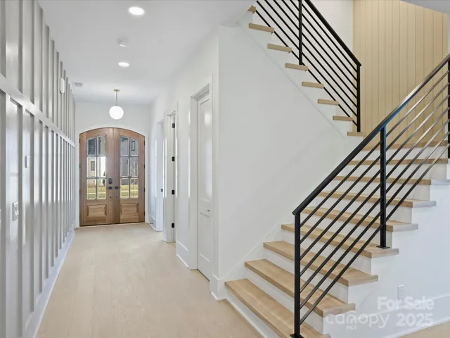 a view of a hallway with entryway wooden floor and front door