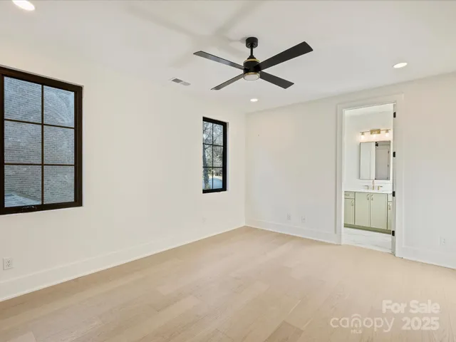 a view of a big room with wooden floor closet and windows