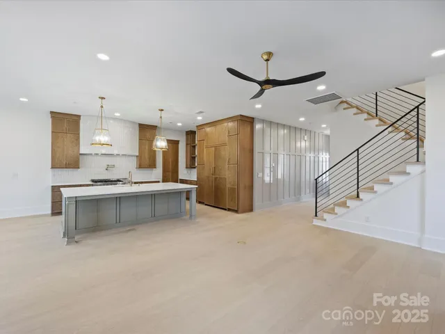 a view of kitchen with refrigerator and window