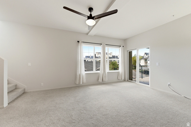 900 Bitner Road, Unit P20 Park City, UT 84098 - Photo 7 of 42 Spacious carpeted room featuring a ceiling fan with integrated lighting, multiple windows, and a sliding glass door opening to a balcony