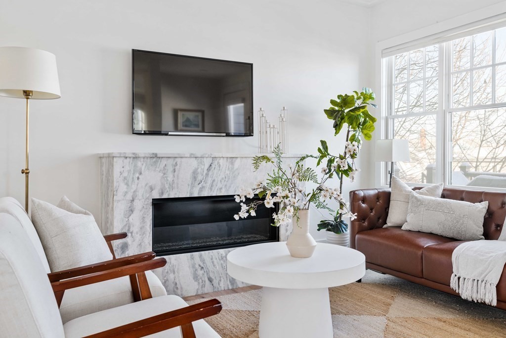 33 Summit Avenue, Unit 33 Brookline, MA 02446 - Photo 12 of 28 a living room with furniture fireplace and a large window