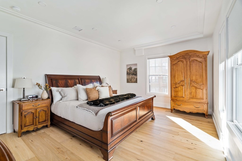 33 Summit Avenue, Unit 33 Brookline, MA 02446 - Photo 16 of 28 a bedroom with a bed and wooden floor