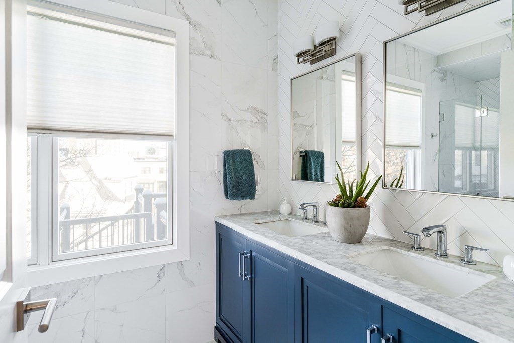 33 Summit Avenue, Unit 33 Brookline, MA 02446 - Photo 18 of 28 a bathroom with a granite countertop sink and a large mirror