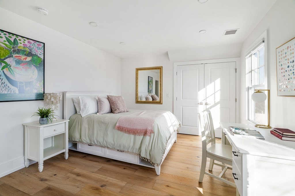 33 Summit Avenue, Unit 33 Brookline, MA 02446 - Photo 21 of 28 a bedroom with a bed and wooden floor