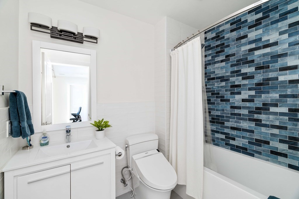 33 Summit Avenue, Unit 33 Brookline, MA 02446 - Photo 24 of 28 a bathroom with a sink a toilet and a mirror