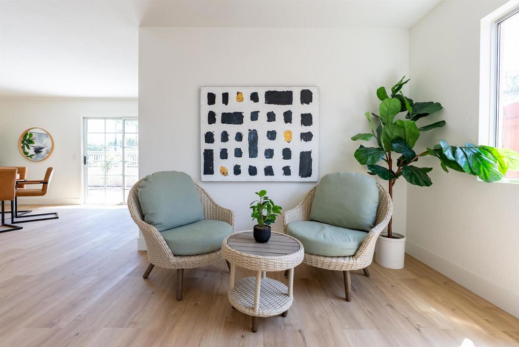 841 Friendly Circle El Cajon, CA 92021 - Photo 11 of 20 a view of a dining room with furniture a potted plant and wooden floor