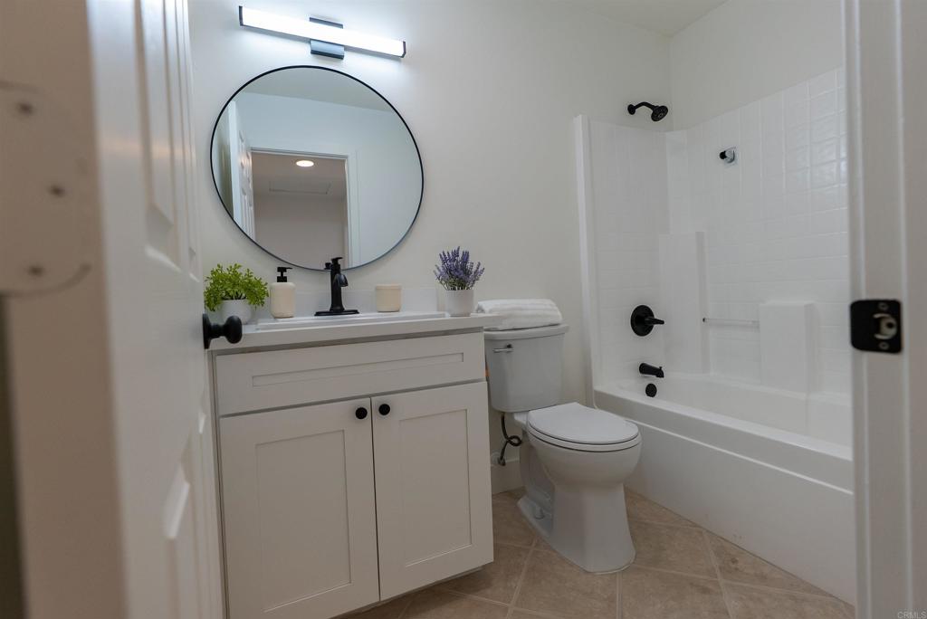 841 Friendly Circle El Cajon, CA 92021 - Photo 14 of 20 a bathroom with a toilet a sink and a mirror