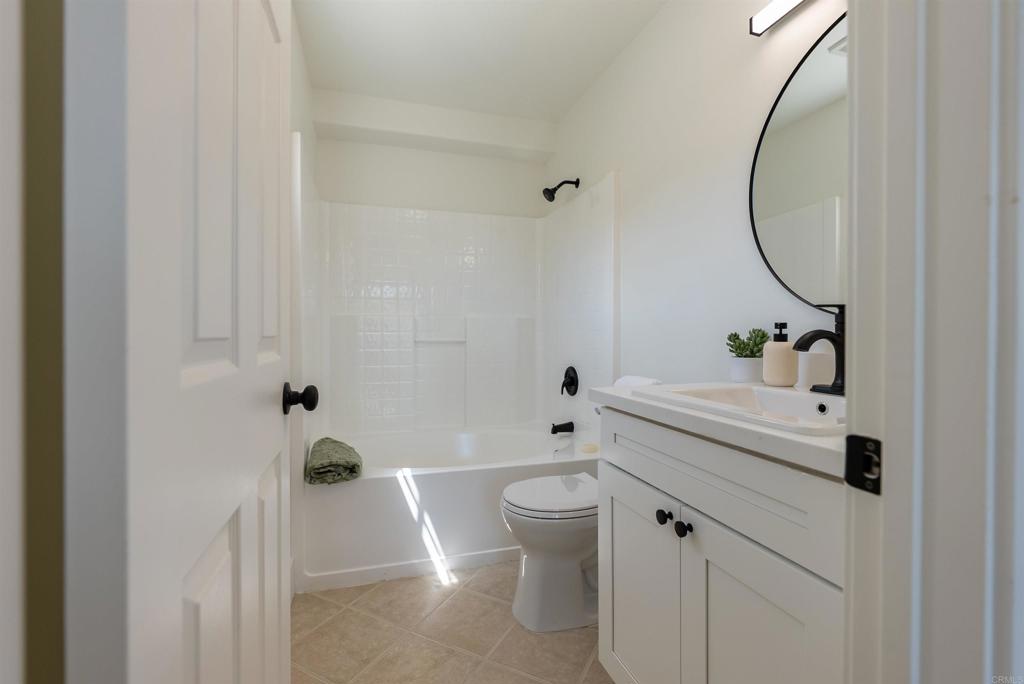 841 Friendly Circle El Cajon, CA 92021 - Photo 16 of 20 a bathroom with a sink a toilet and a mirror