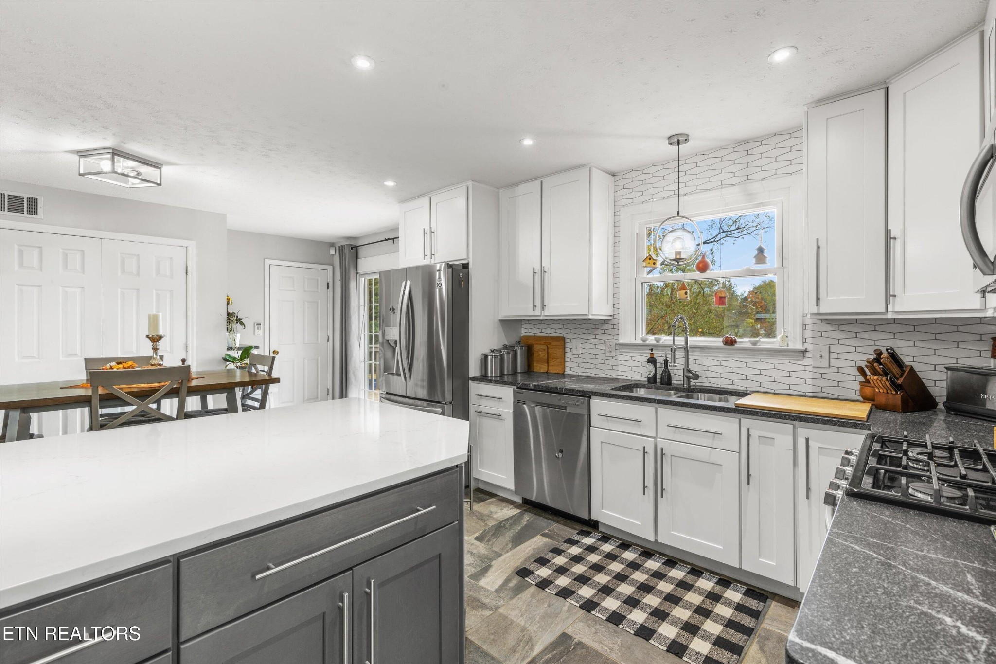 7919 North Forest Road Knoxville, TN 37909 - Photo 13 of 29 a kitchen with stainless steel appliances a sink a stove a refrigerator cabinets and living room view