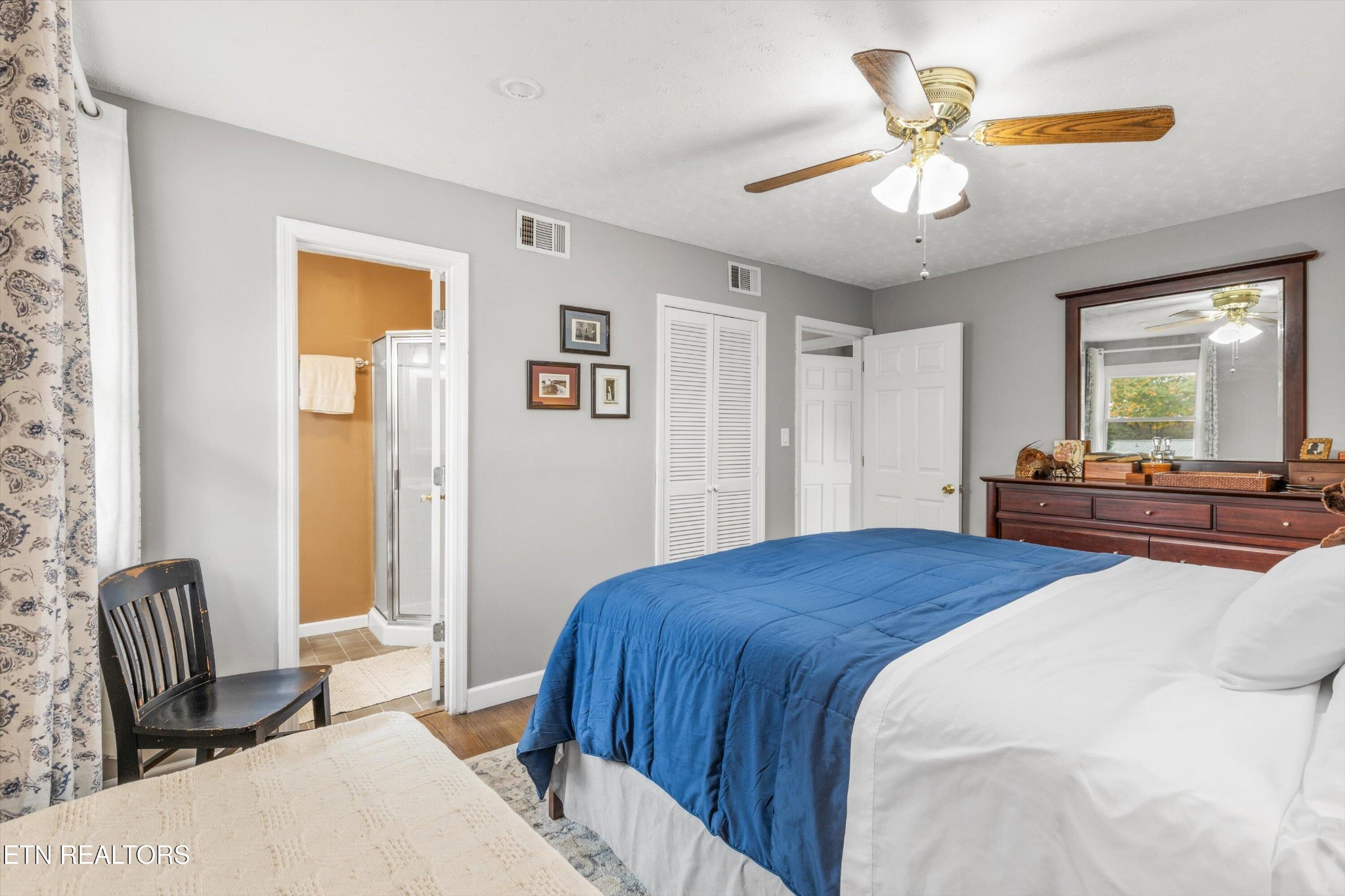 7919 North Forest Road Knoxville, TN 37909 - Photo 18 of 29 a bedroom with a bed and a chandelier