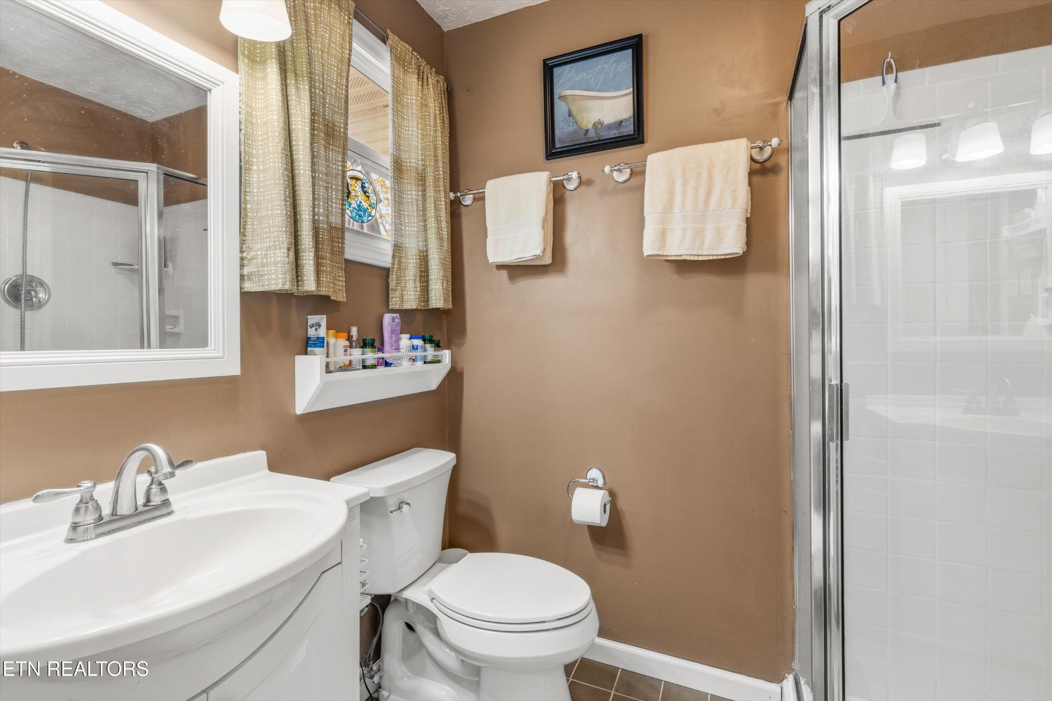 7919 North Forest Road Knoxville, TN 37909 - Photo 19 of 29 a bathroom with a sink toilet and mirror