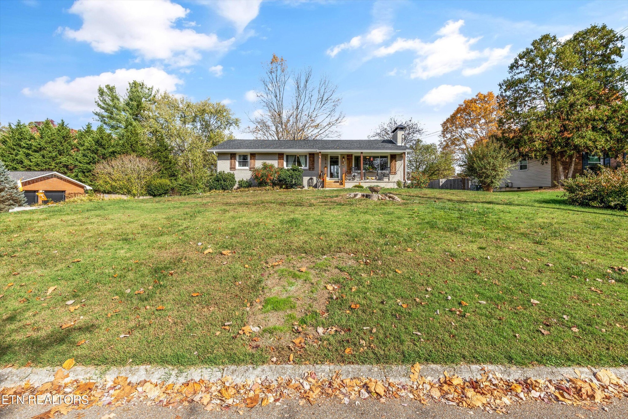 7919 North Forest Road Knoxville, TN 37909 - Photo 2 of 29 a view of a big house with a big yard and large trees