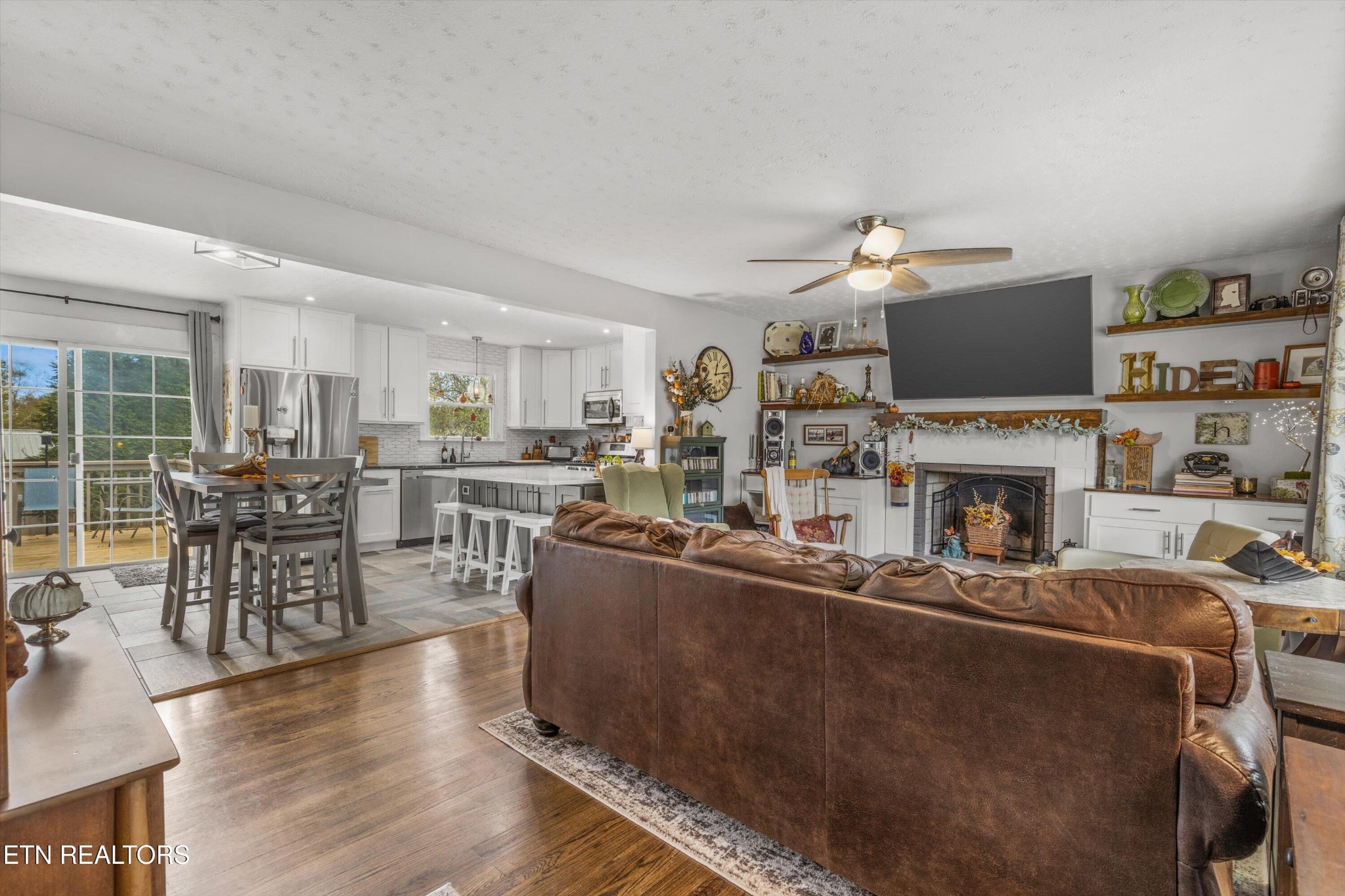 7919 North Forest Road Knoxville, TN 37909 - Photo 5 of 29 a living room with furniture a fireplace and a flat screen tv