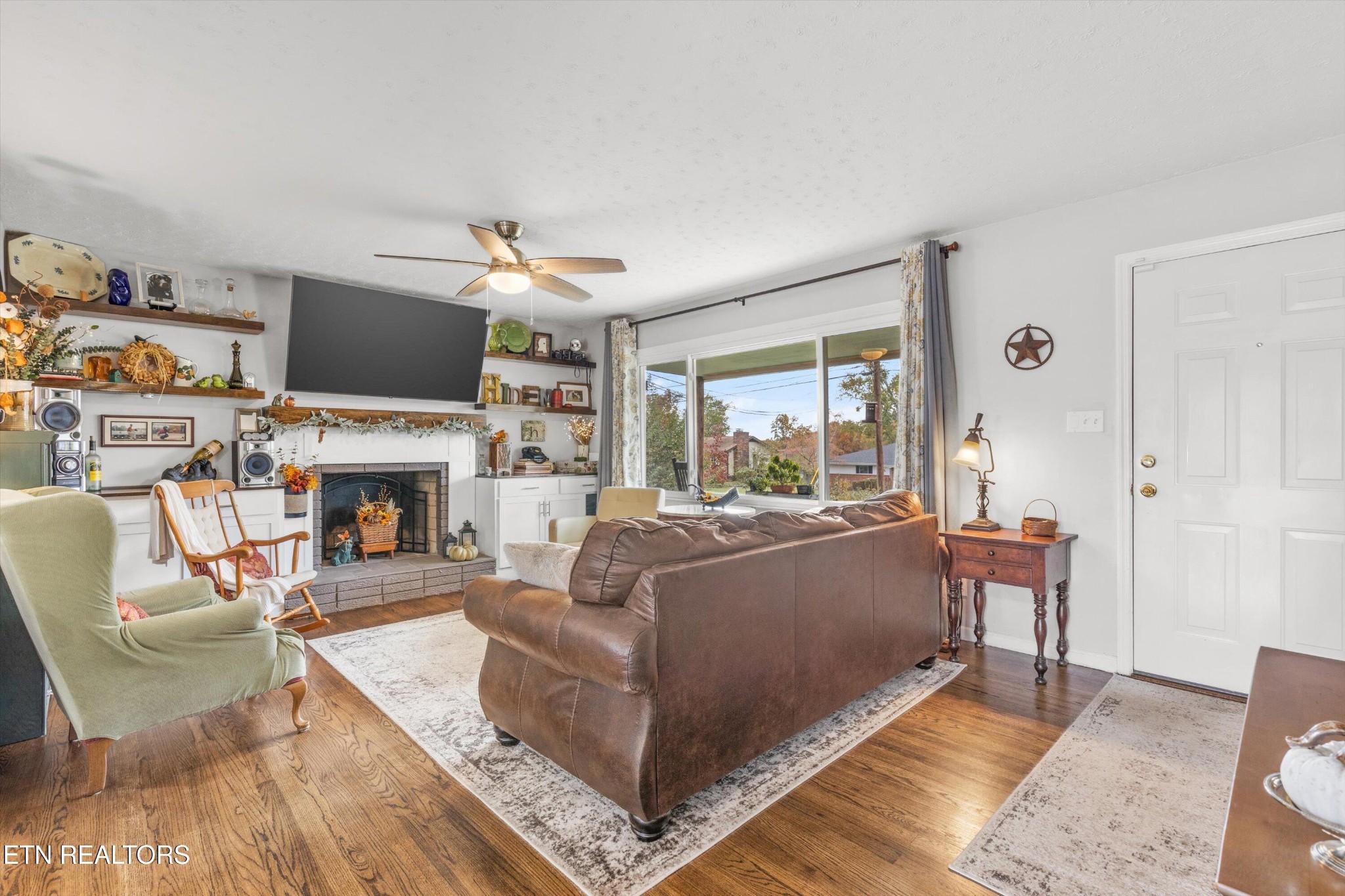 7919 North Forest Road Knoxville, TN 37909 - Photo 6 of 29 a living room with furniture a fireplace and a flat screen tv