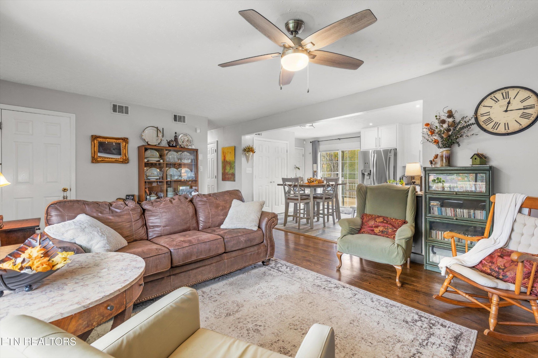 7919 North Forest Road Knoxville, TN 37909 - Photo 7 of 29 a living room with furniture a rug and a ceiling fan
