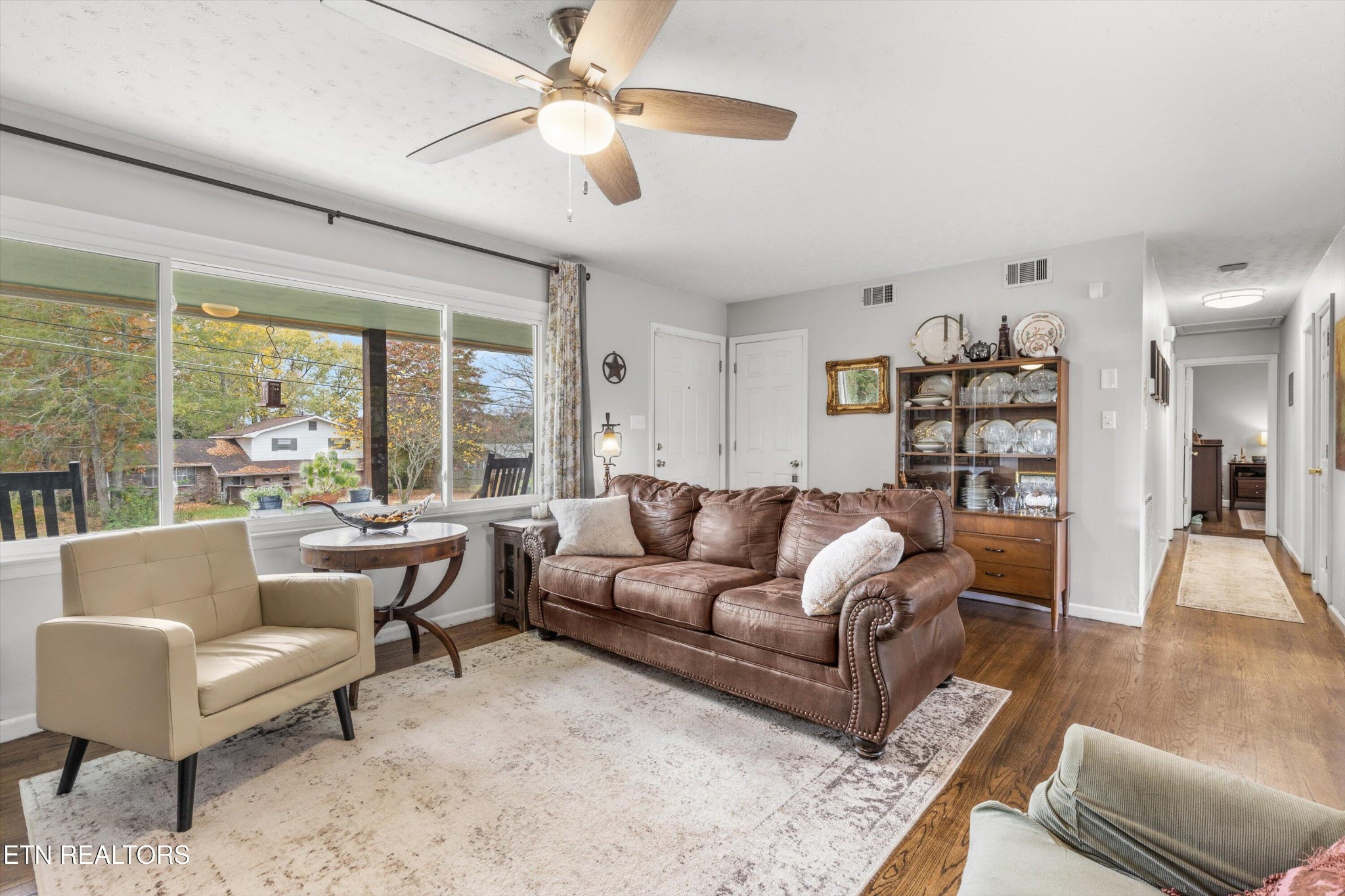 7919 North Forest Road Knoxville, TN 37909 - Photo 8 of 29 a living room with furniture and a large window with kitchen view