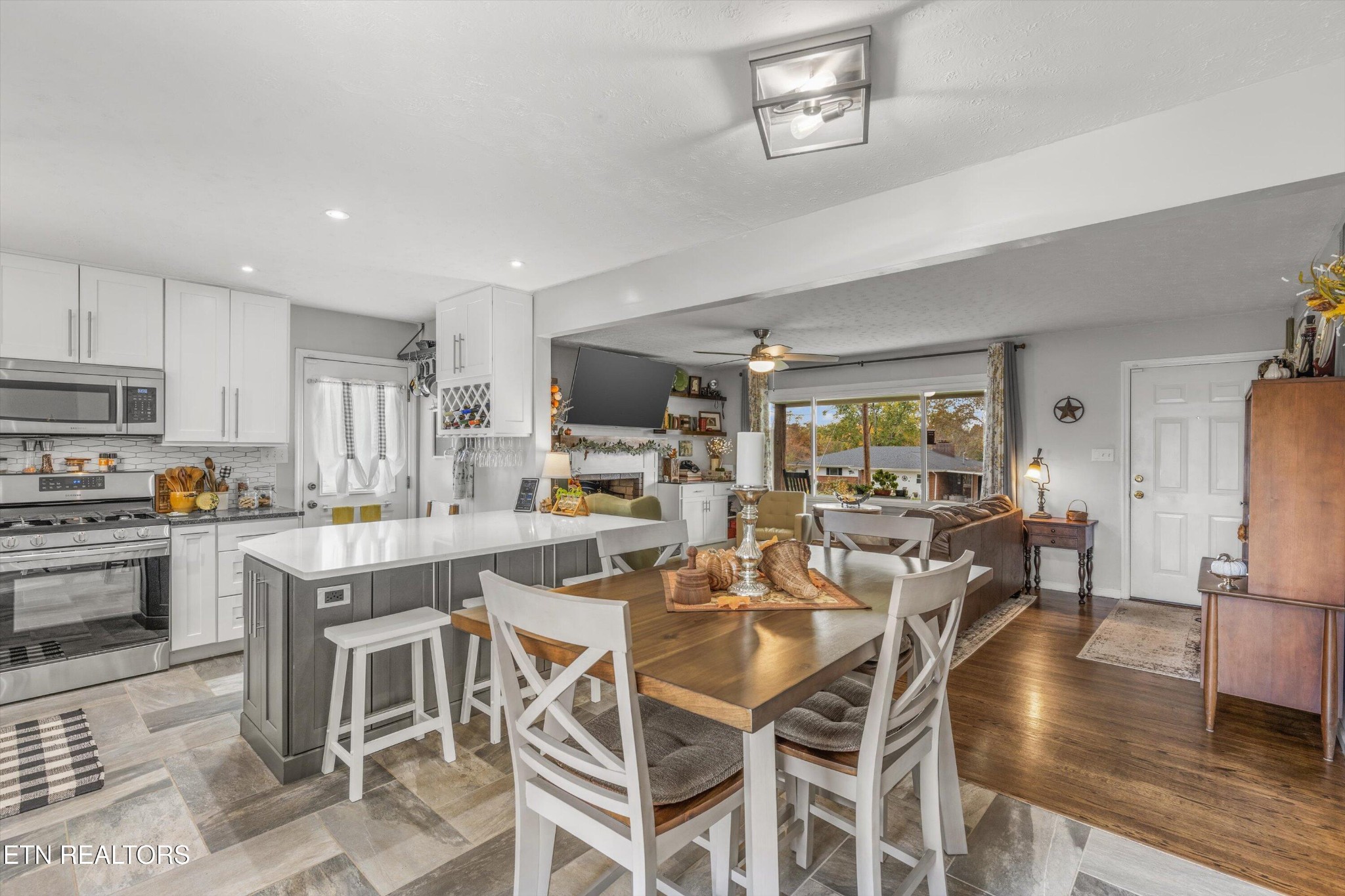 7919 North Forest Road Knoxville, TN 37909 - Photo 10 of 29 a view of a dining room with furniture a kitchen and chandelier