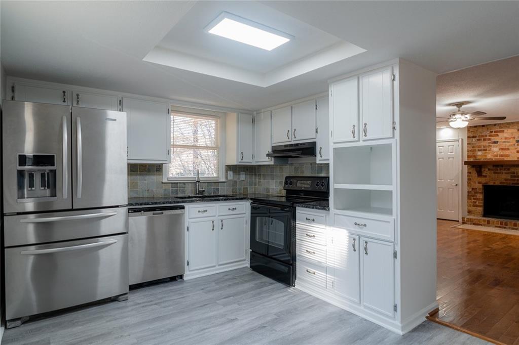 3599 Lower Roswell Road Marietta, GA 30068 - Photo 15 of 64 a kitchen with granite countertop white cabinets and stainless steel appliances