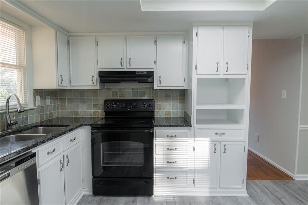 3599 Lower Roswell Road Marietta, GA 30068 - Photo 17 of 64 a kitchen with cabinets appliances and a window