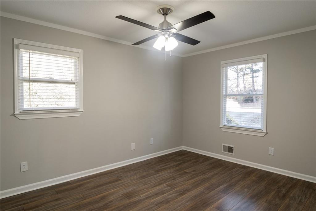 3599 Lower Roswell Road Marietta, GA 30068 - Photo 32 of 64 a view of an empty room with wooden floor and a window