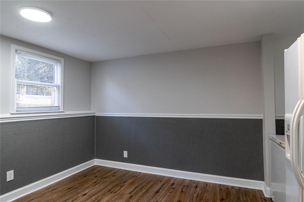 3599 Lower Roswell Road Marietta, GA 30068 - Photo 44 of 64 a view of an empty room with wooden floor and a window