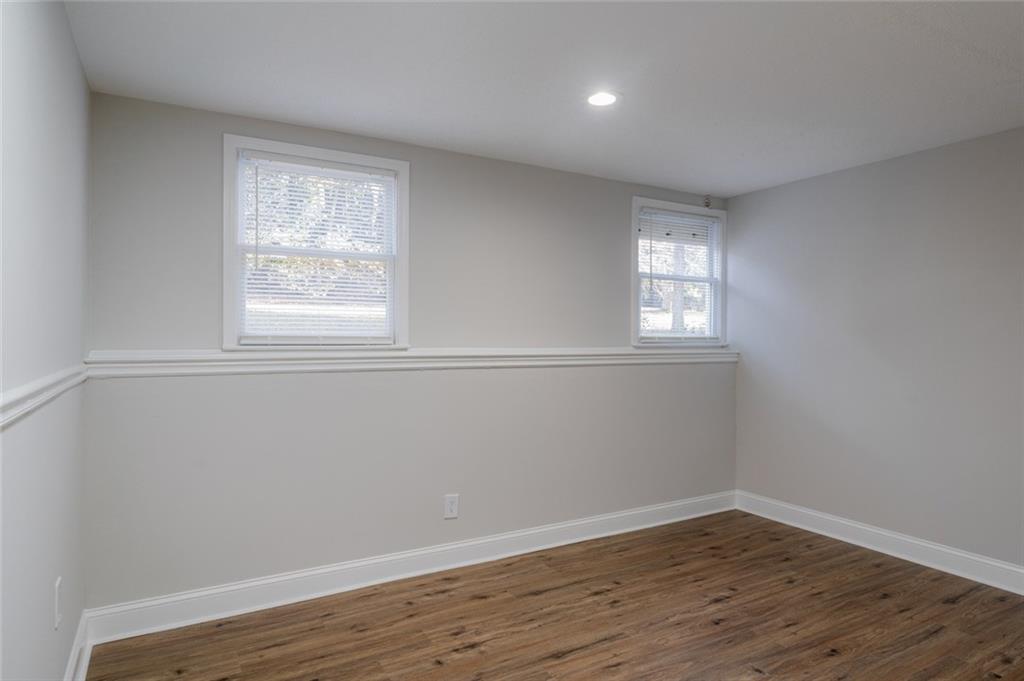 3599 Lower Roswell Road Marietta, GA 30068 - Photo 47 of 64 an empty room with wooden floor and windows