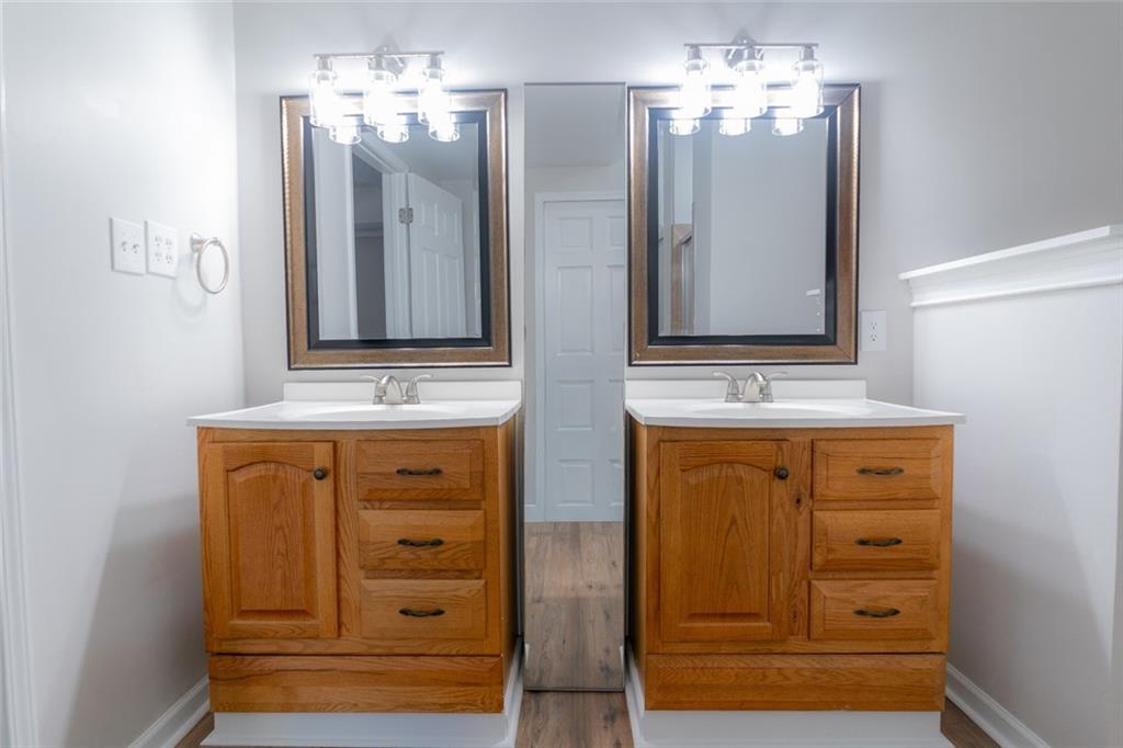 3599 Lower Roswell Road Marietta, GA 30068 - Photo 60 of 64 a bathroom with a double vanity sink and a mirror