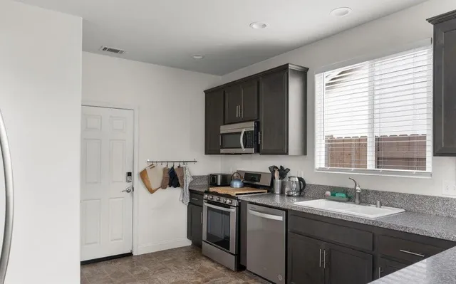 a kitchen with lots of counter top space and a window