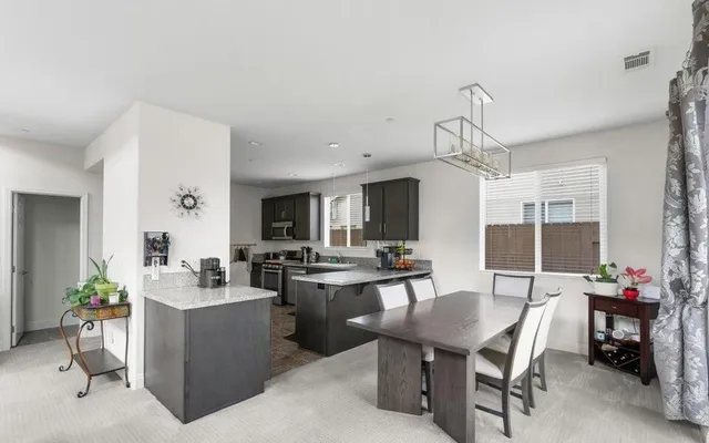 a view of a dining room with furniture window and outside view