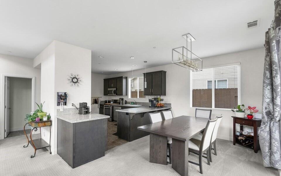 4575 Castillo Drive Guadalupe, CA 93434 - Photo 8 of 24 a view of a dining room and livingroom with furniture wooden floor a chandelier