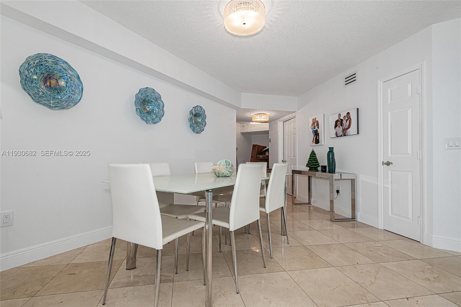 6301 Collins Avenue, Unit 1605 Miami Beach, FL 33141 - Photo 11 of 23 a dining room with furniture and a window