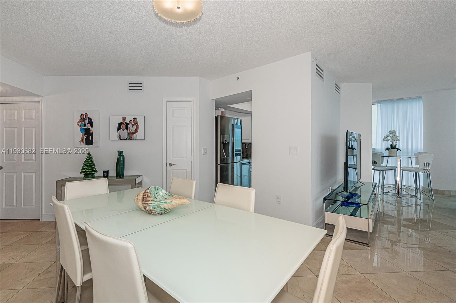 6301 Collins Avenue, Unit 1605 Miami Beach, FL 33141 - Photo 12 of 23 a dining room with table and chair