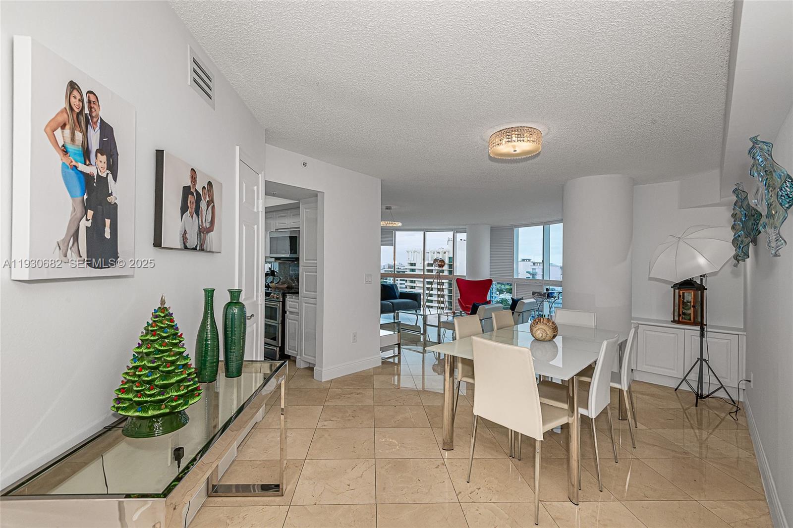 6301 Collins Avenue, Unit 1605 Miami Beach, FL 33141 - Photo 13 of 23 a view of a dining room with furniture and chandelier