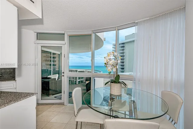 a dining room with table chairs and entryway