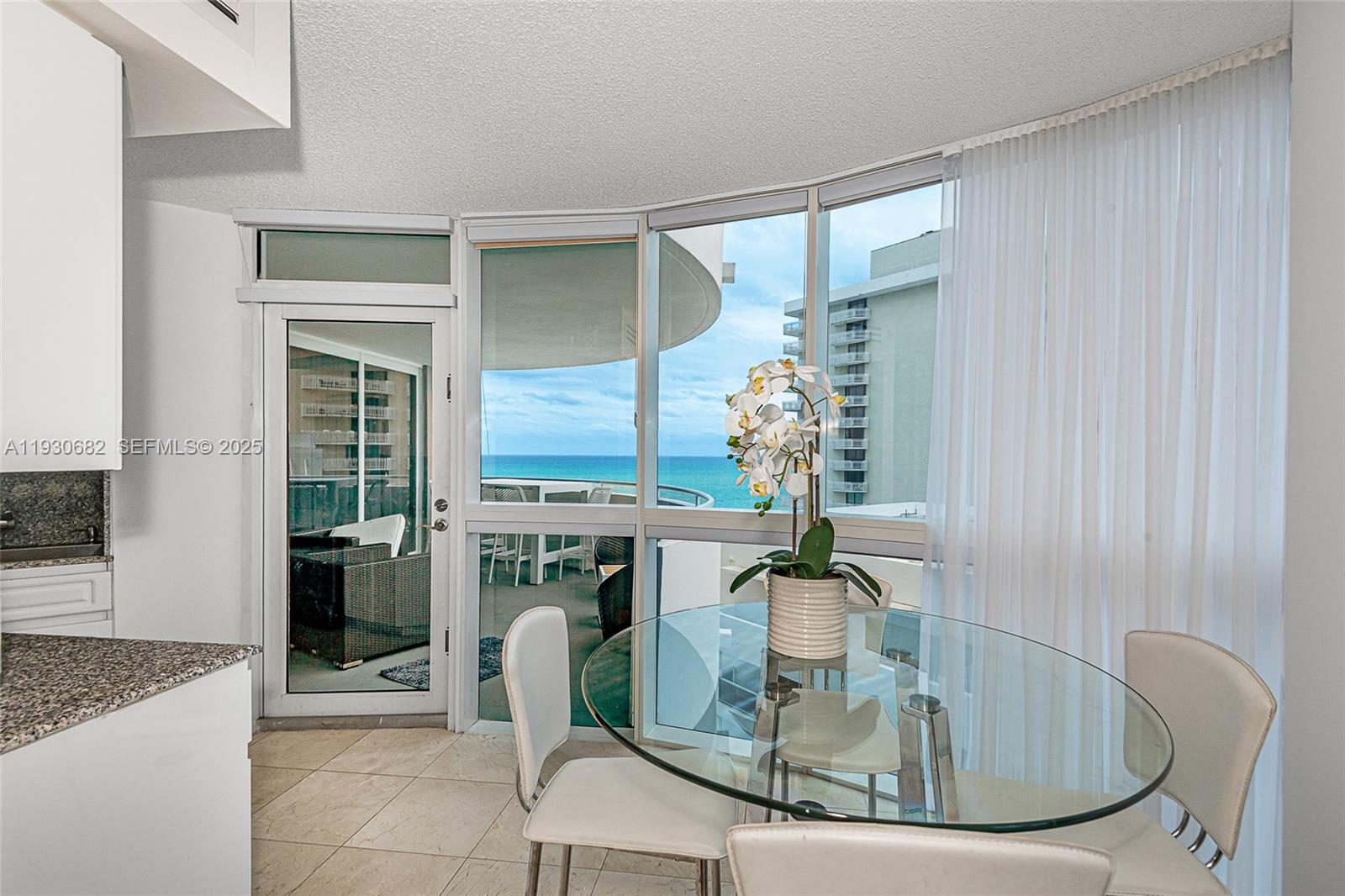 6301 Collins Avenue, Unit 1605 Miami Beach, FL 33141 - Photo 17 of 23 a dining room with table chairs and entryway